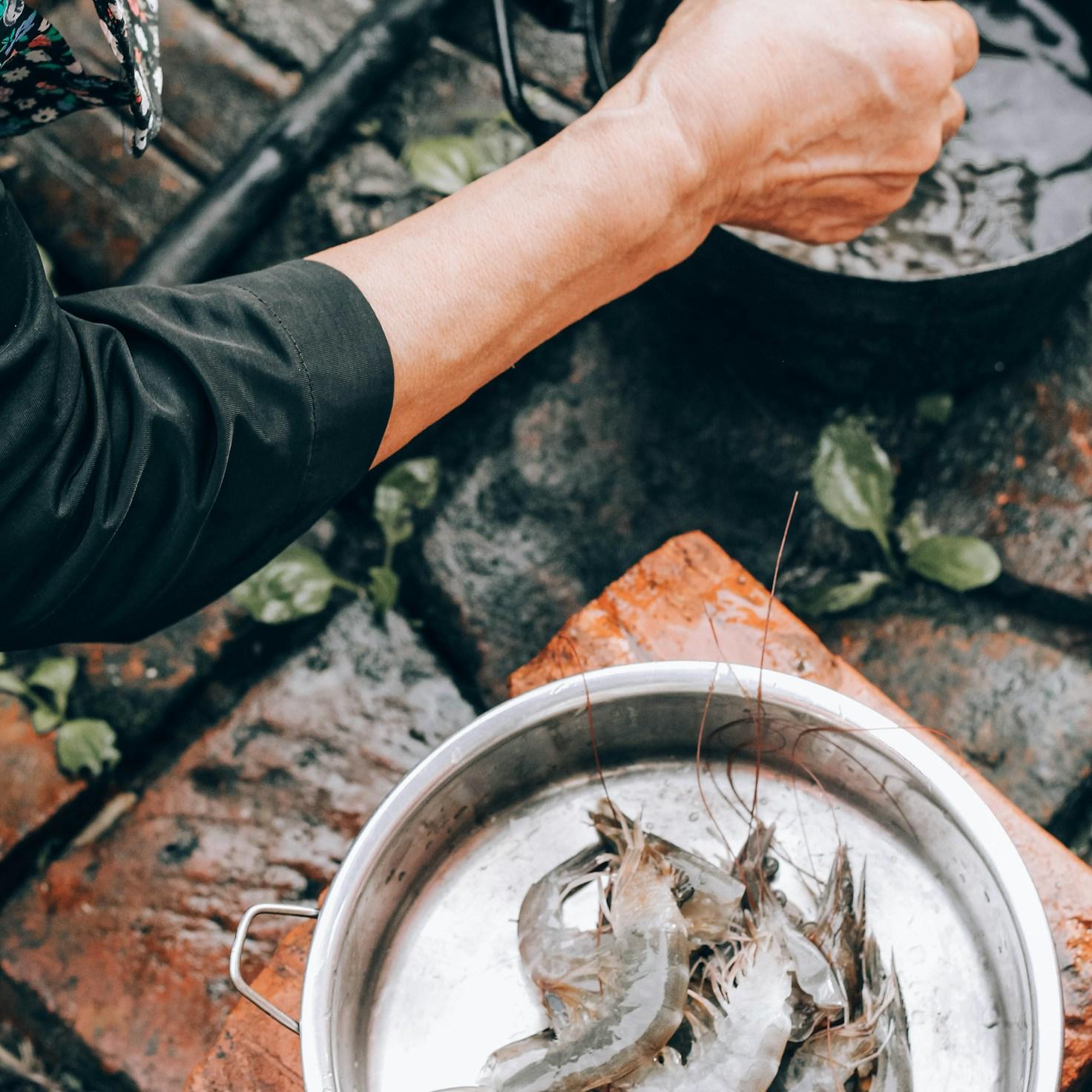 Diverse group of community members sharing a meal, highlighting the bonds built through collaborative cooking